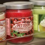 Pet Odor Exterminator candle close-up in retail display.